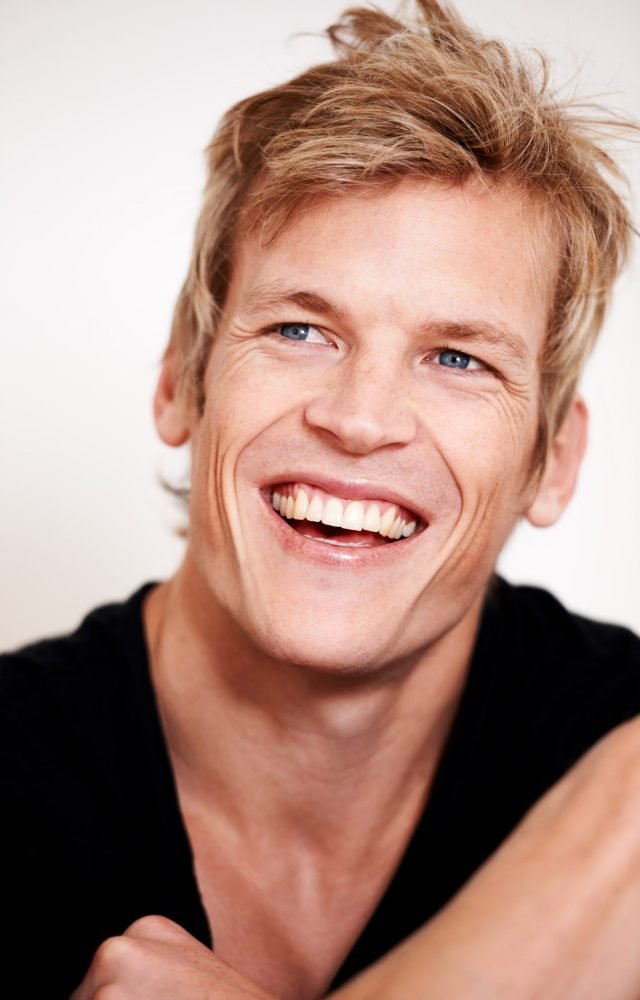sensational-smile-cropped-shot-handsome-young-man-posing-studio-min